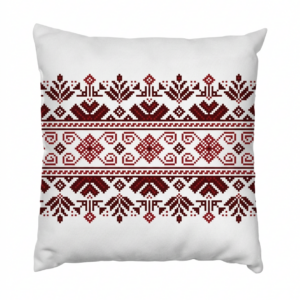 HOME A single tribal medallion takes center stage on this natural ivory cushion — a compass-like cross of geometric motifs embroidered in terracotta, deep brown, and lilac. Understated in size, unforgettable in detail.